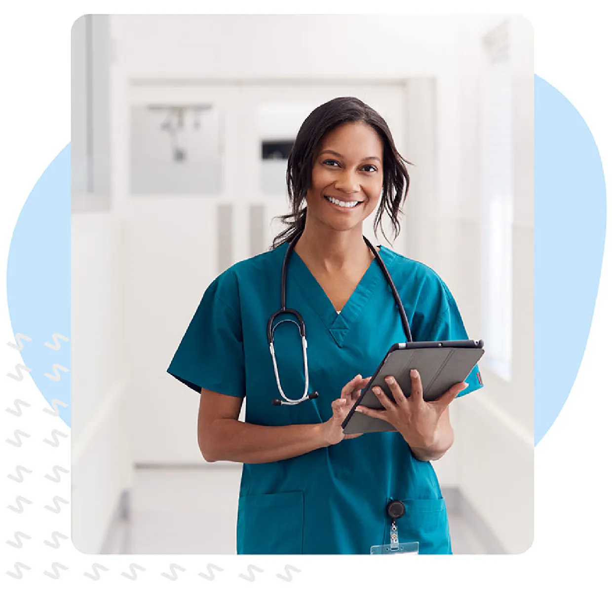 Nurse in scrubs works on a tablet