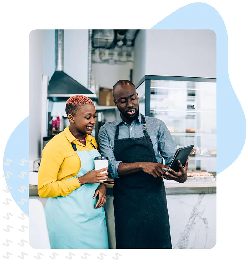 Bakery employees using a tablet to schedule and communicate